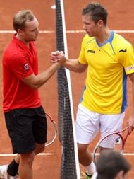 Belgian Steve Darcis (L) shakes hands with Swedish Michael Ryderstedt